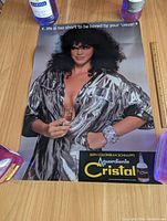 Full view of the vintage Aguardiente Cristal promotional poster showing a woman in a metallic silver top holding a glass with the Cristal logo, text above and product branding below.
