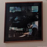 Full view of the framed art print showing the overall composition of the man playing piano in dark and cool tones, displaying the vintage wooden frame.
