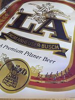 Close-up image showing the top half of the poster with large 'LA' and Anheuser-Busch eagle logo