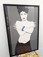 Full view of framed Patrick Nagel Jeana print showing female figure with arms crossed and red lips.