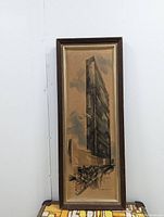 Full view of the vintage framed United Nations building print showing entire artwork and frame.
