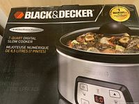 Box of Black & Decker 7-quart digital slow cooker with partial view of product and branding showing.