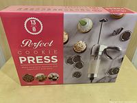 Photo of boxed Perfect Cookie Press showing front with product image and some cookies.