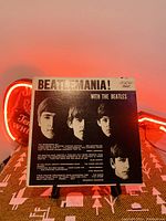 Front cover of 'Beatlemania! with The Beatles' vinyl LP showing band member photos and the title.
