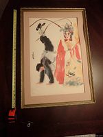 Full front view of framed watercolor painting laid flat with tape measure alongside