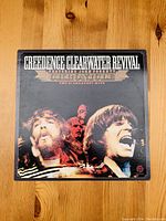 Front cover of the vinyl album showing the band's name, album title, and images of band members.