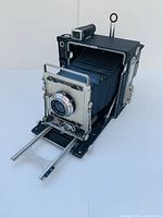 Front three-quarter view showing camera body, bellows and attached lens