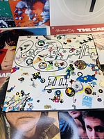 Front cover of Led Zeppelin III with colorful illustrations and lettering.