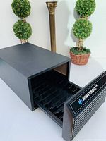 Side angled view with the drawer partially open, showing the cartridge slots inside