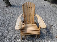 Front view of folding Adirondack chair showing slatted wooden seat, wide armrests, and cup holder on one armrest.