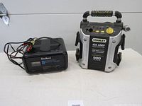 DieHard Manual Operation Battery Charger and Stanley 450 AMP Battery Booster side by side on table
