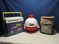 Three coolers shown: Big Bobber floating cooler center, Smarties cooler left, Ozark Trail backpack cooler right