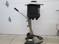 Side view of Blue Rhino Skeeter Vac with wheels and handle, black motor housing and metal frame.