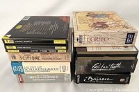 Stack of 8 boxed opera CD sets showing titles by Gluck, Handel, LeClair, Monteverdi, Mozart, and Vivaldi in their original cases.
