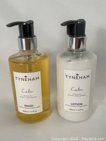 Front view of Tyneham Calm body wash and lotion in clear pump bottles.