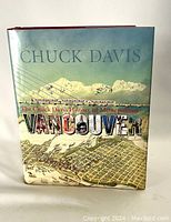 Front cover of the book showing illustrated map of Vancouver with mountains in background and title text.