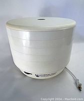 Side view of assembled American Harvest Snackmaster Dehydrator showing the stacked trays and lid