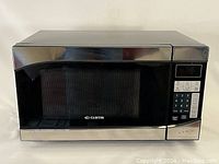 Front view of Curtis microwave oven showing overall design and logo on the door