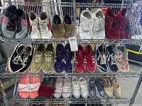 Three rows of various women's and children's shoes including sneakers and sandals of multiple colors and styles