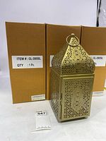 Four new metal candle cages in front of their boxes with labels showing item number GL-39058L