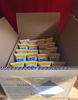 Open cardboard box showing 24 tubes of Wish hand sanitizer arranged upright inside with visible labels.