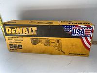 Closed original yellow DeWalt box showing model DWE304 and Made in USA with global materials branding.