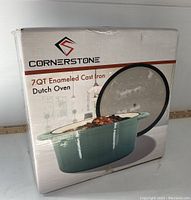 Front view of the boxed Cornerstone 7QT enameled cast iron Dutch oven showing the product image and branding.