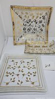 Three Georges Briard signed clear glass snack plates with gold designs and minor wear.