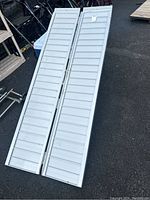 Photo of the ramp folded in half and resting on the ground, showing length and width.