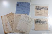 Photo showing a collection of assorted vintage documents including receipts, mortgage papers, and handwritten notes with visible aging signs
