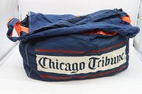 Original vintage blue fabric newspaper bag with 'Chicago Tribune' logo on the side, showing front and top with strap and orange interior lining.