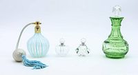 Photo showing all four vintage perfume bottles grouped together on white background.