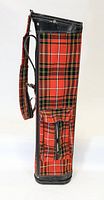 Side view showing red and black plaid pattern and zippered pocket on the golf bag