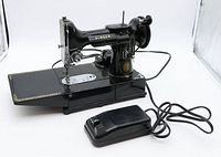 Overall view of Singer machine, motor and foot controller on white background