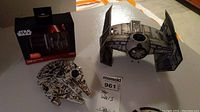 Photo showing the 1970's TIE Fighter model, Millennium Falcon model, and Star Wars magnet set packaging