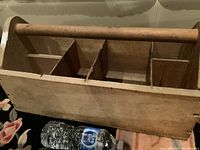 Top-front angled view showing box compartments, handle, and exterior wood grain with vintage wear.