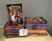 Photo of complete Cheers DVD set, all 11 seasons shown stacked and arranged with season one upright.