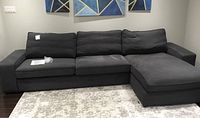 Front view of dark grey Kivik sectional sofa with chaise on right side
