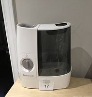 Front view of Honeywell warm mist air humidifier showing control dial and transparent water tank
