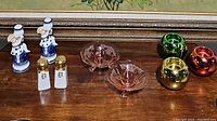 Full lot display including candlestick holders, salt and pepper shakers, pink glass candle holders, and metallic votive holders