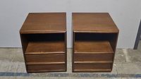 Two vintage wooden night stands side by side, showing front view with their drawer and shelf.