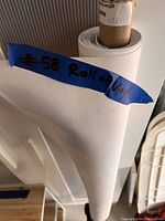 Roll of white vinyl material with blue tape labeling it as #58 Roll of Vinyl