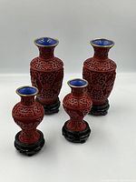 All four vases with stands displayed together on white background
