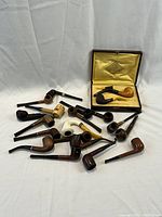 Overview of all 20 pipes and fitted-lined box on white background