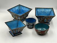 Five cloisonné vessels grouped on white background.
