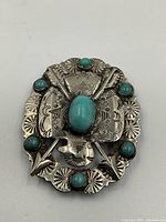 Top-down view of brooch showing overall design and stamped pattern