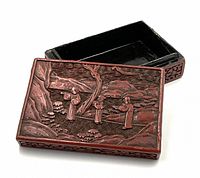 Lid removed to show carved scene on lid and black lacquer interior