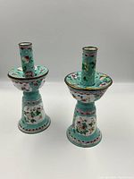 Front view of both candlesticks on white background