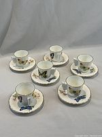All six demitasse cups and saucers arranged in two rows.