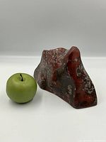 Front profile with green apple for scale, showing overall shape and color distribution